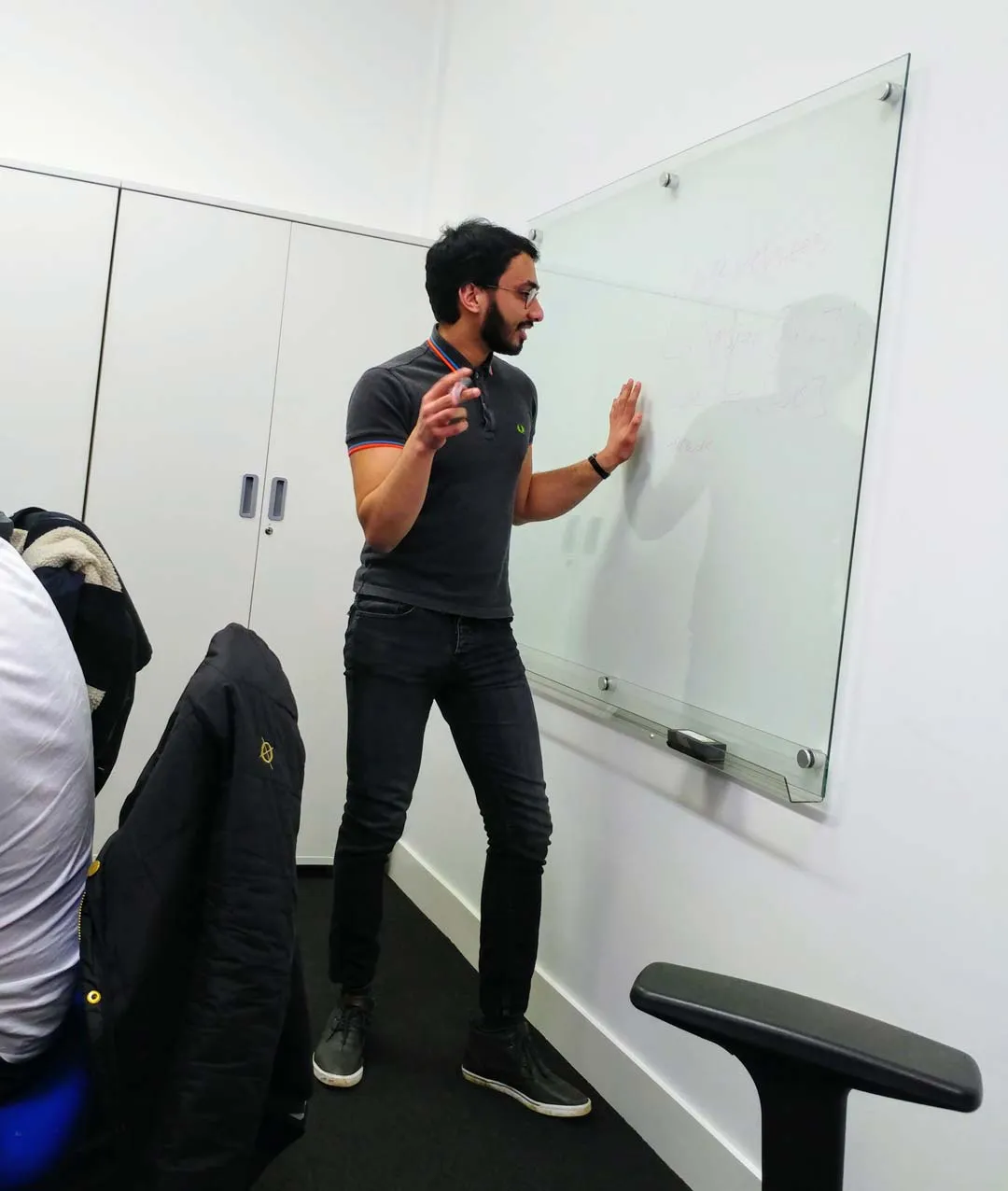 Iman Hussain explaining a concept to his group